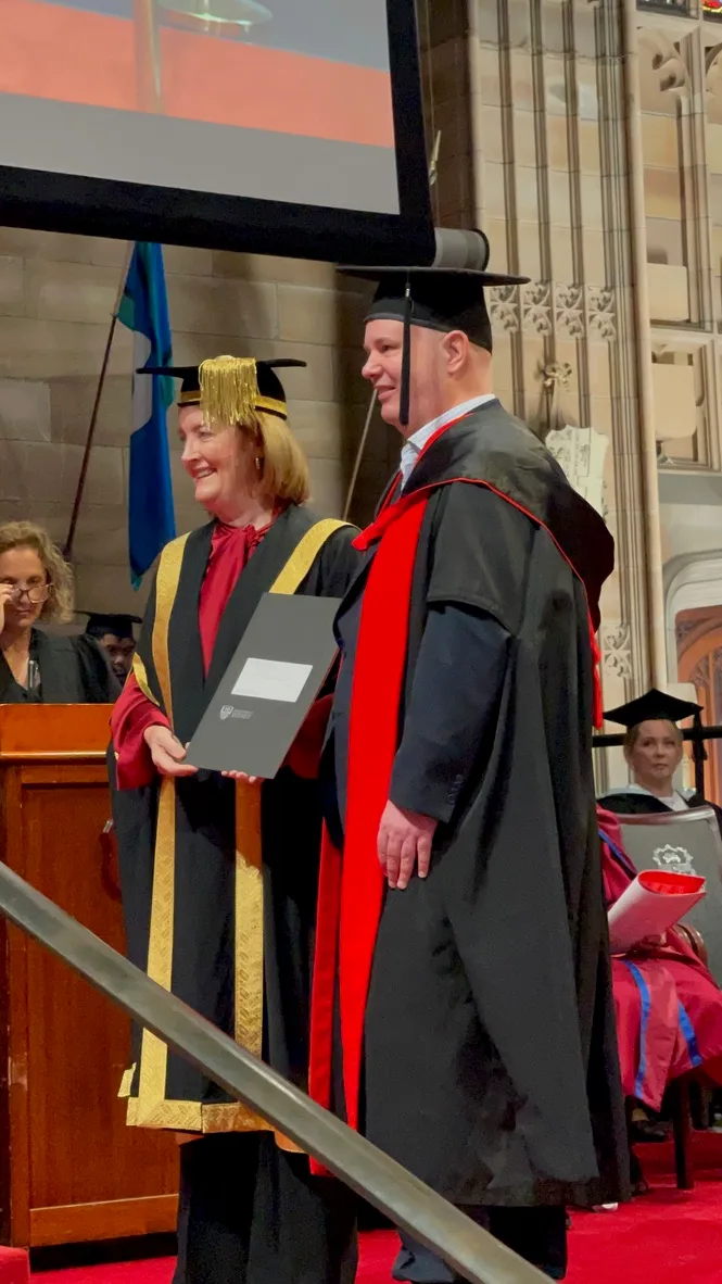 Dr Adrian Hunt receiving his PhD at the University of Sydney Great Hall, December 2025